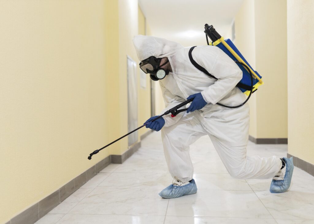 full-shot-man-disinfecting-building